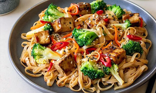A bowl of hot Tofu Teriyaki Noodles with broccoli