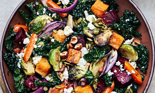 A large bowl of Roasted Vegetable Salad with mixed greens
